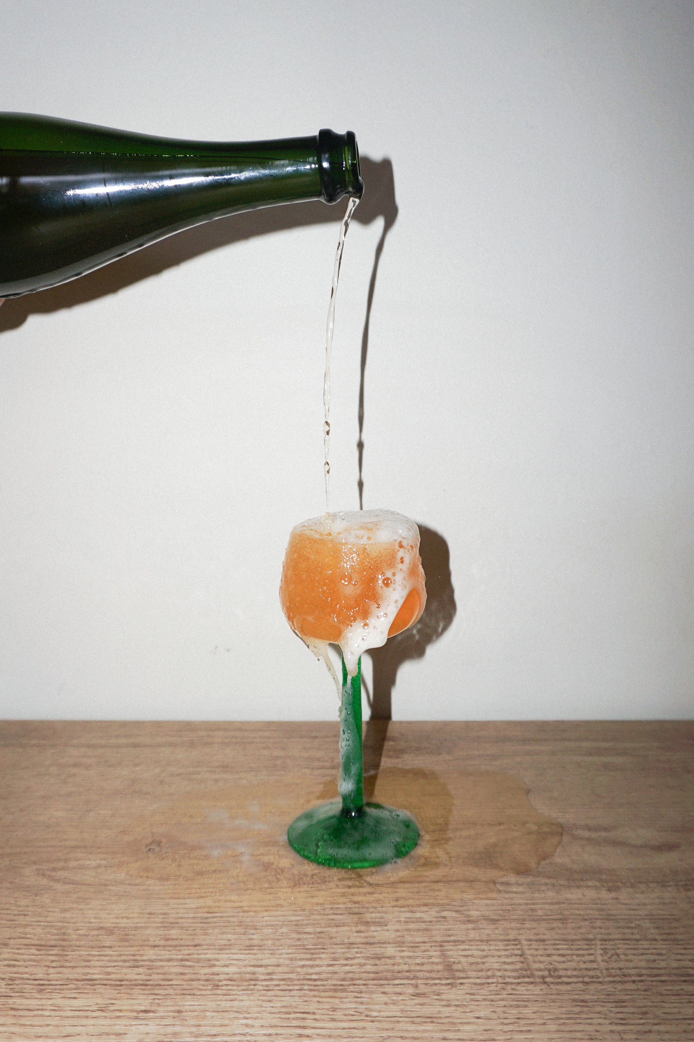 Arriba organic orange wine being poured into a wine glass showing its natural amber colour