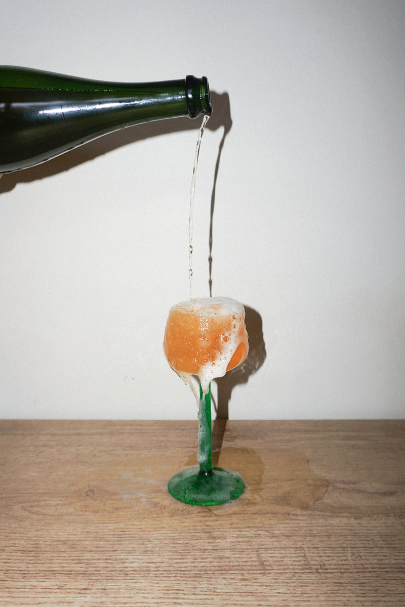 Arriba organic orange wine being poured into a wine glass showing its natural amber colour