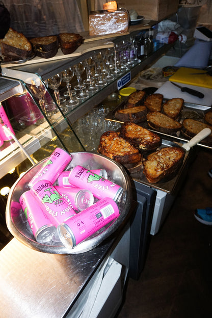 Session Fizz organic sparkling canned wine chilling in an ice bucket alongside food at a party by Loco Wines