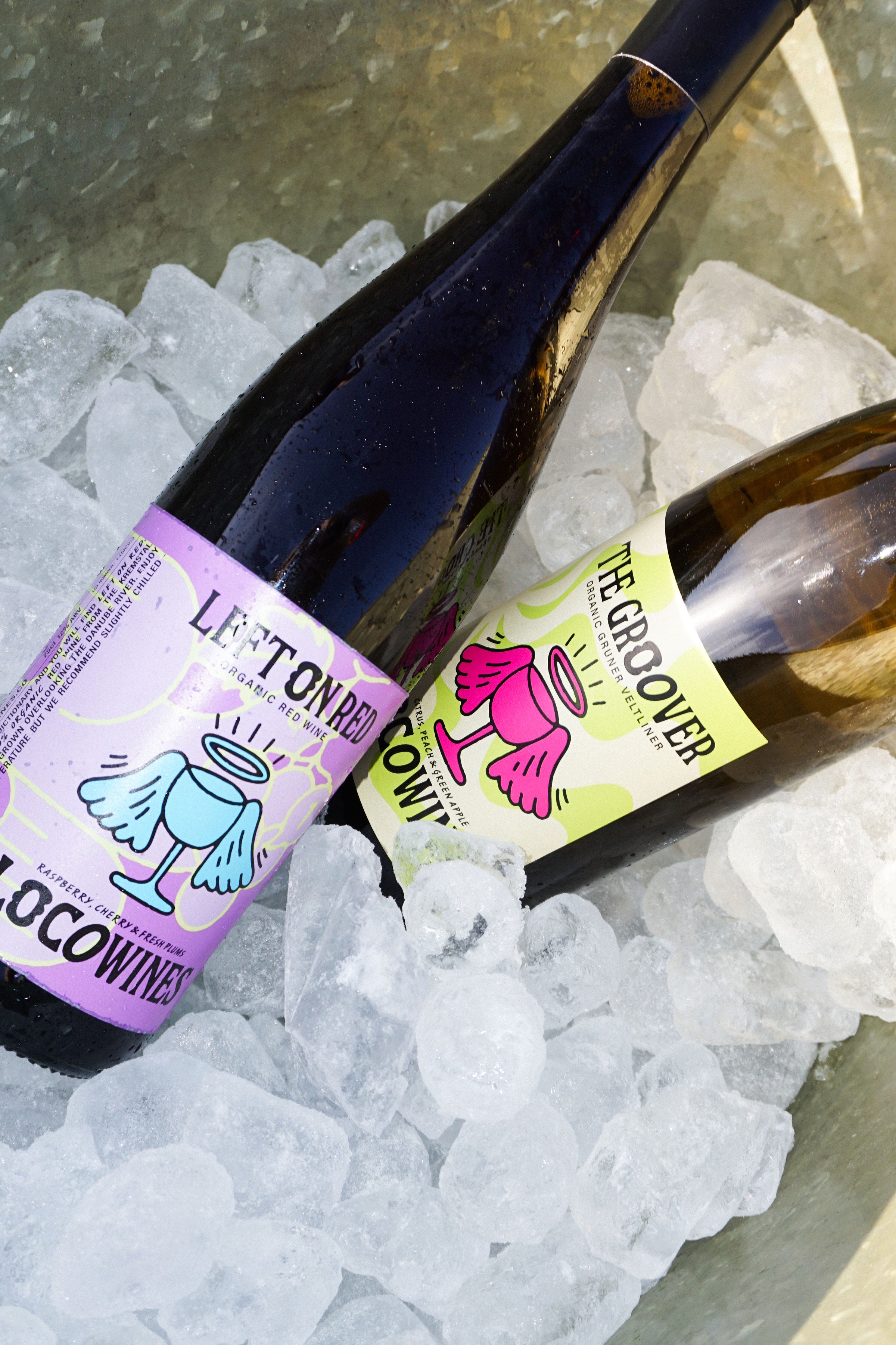Left on Red organic red wine and The Groover organic white wine bottles chilling together in an ice bucket by Loco Wines